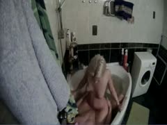 A woman on a beach is seen massaging her lover's cock in a hidden camera video.